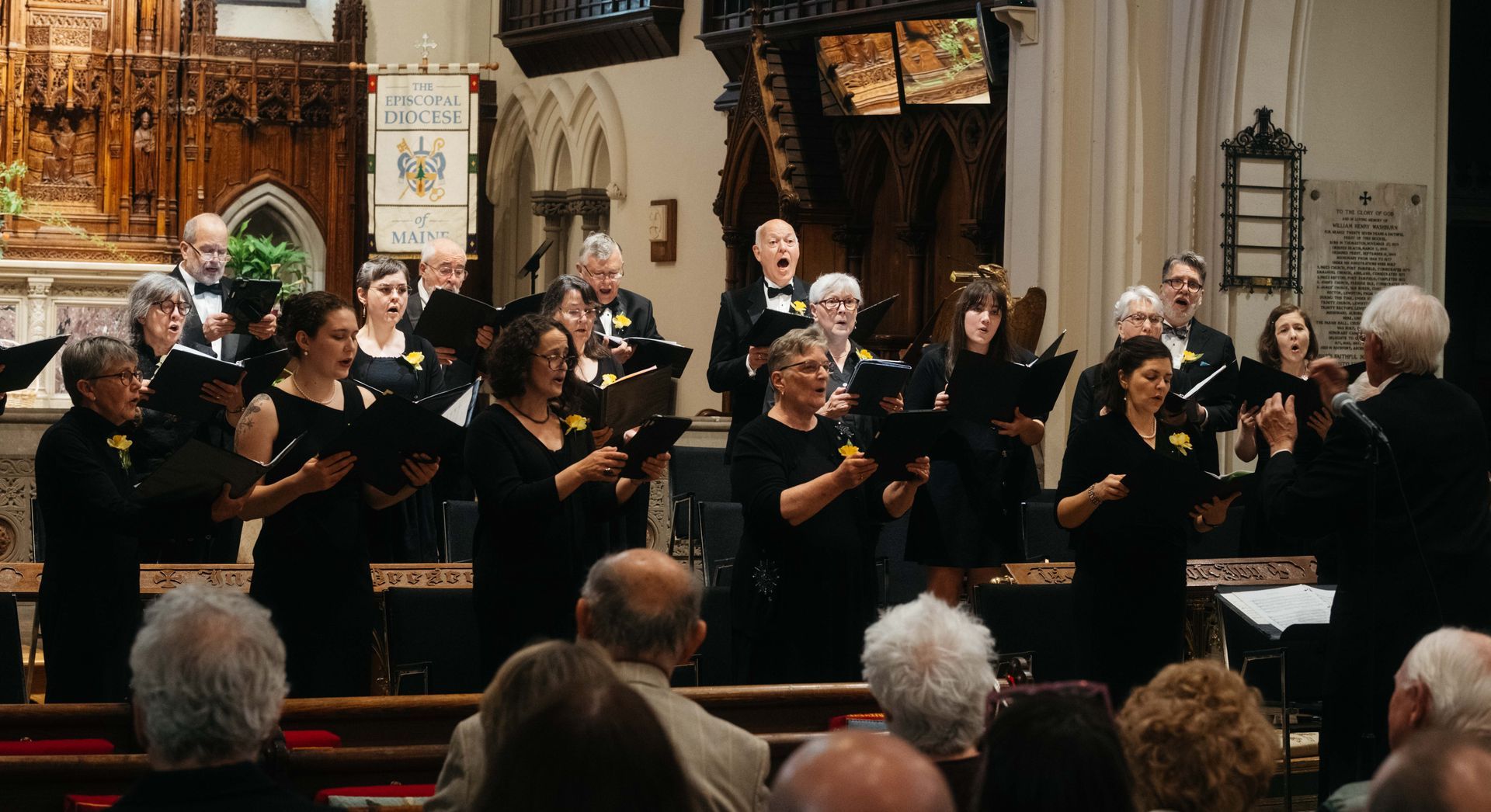 A woman is reading sheet music in a choir