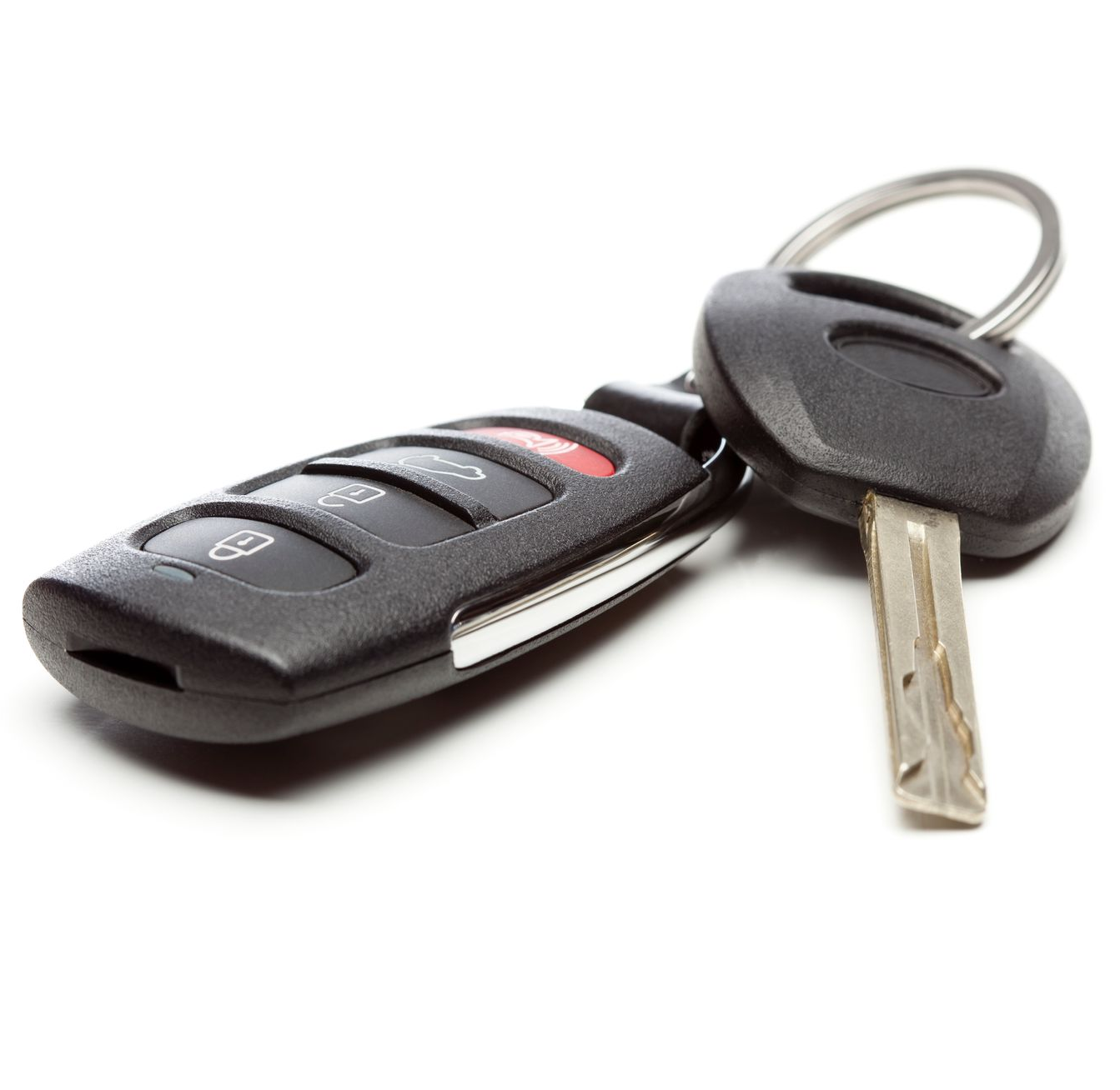 Black car key fob with buttons and a metal key on a key ring, isolated on white background