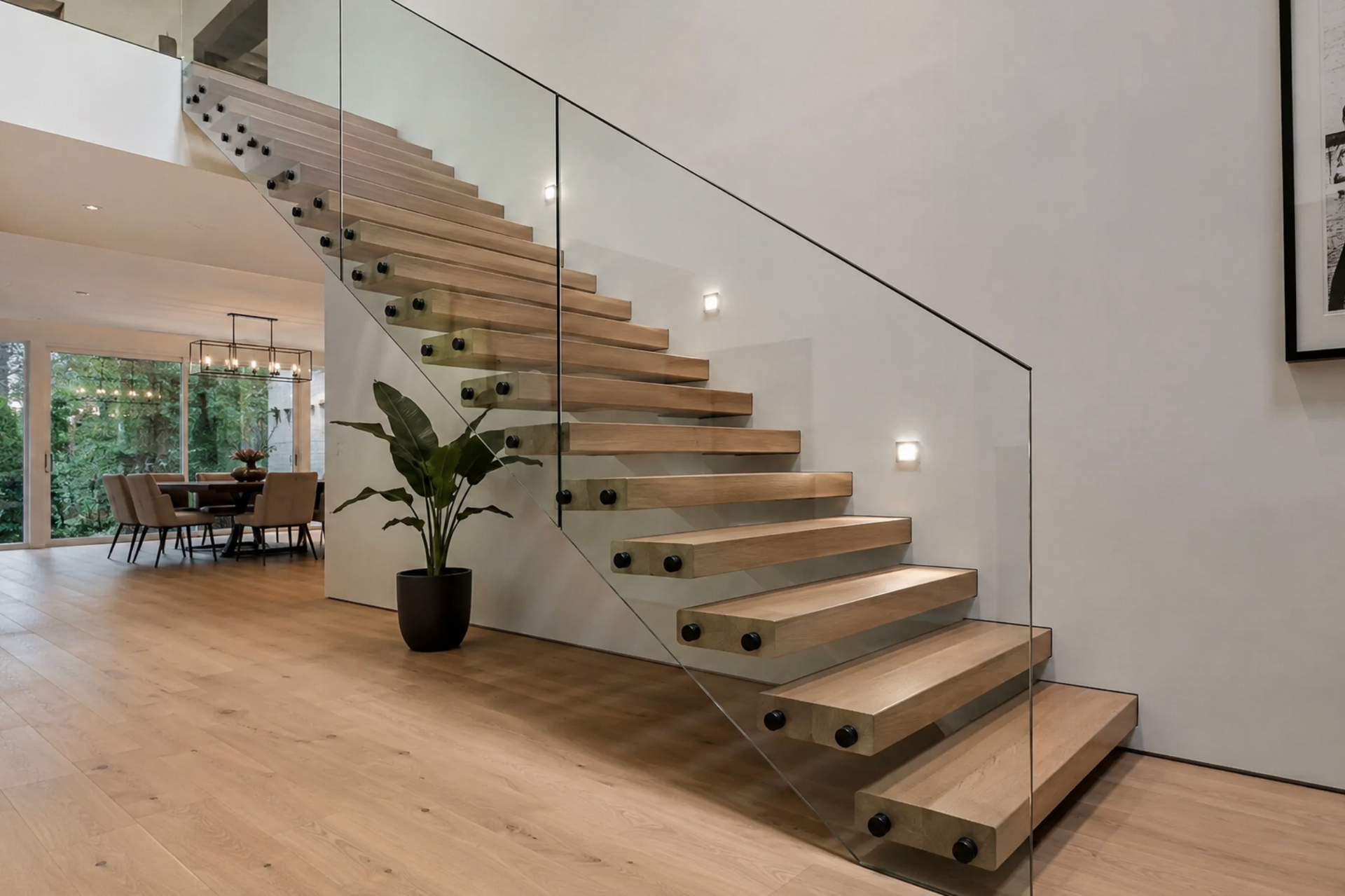 Modern open staircase with glass railing in a bright minimalist living room