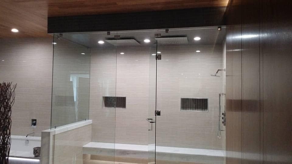 Glass double doors in a modern lobby with a wood ceiling and white walls