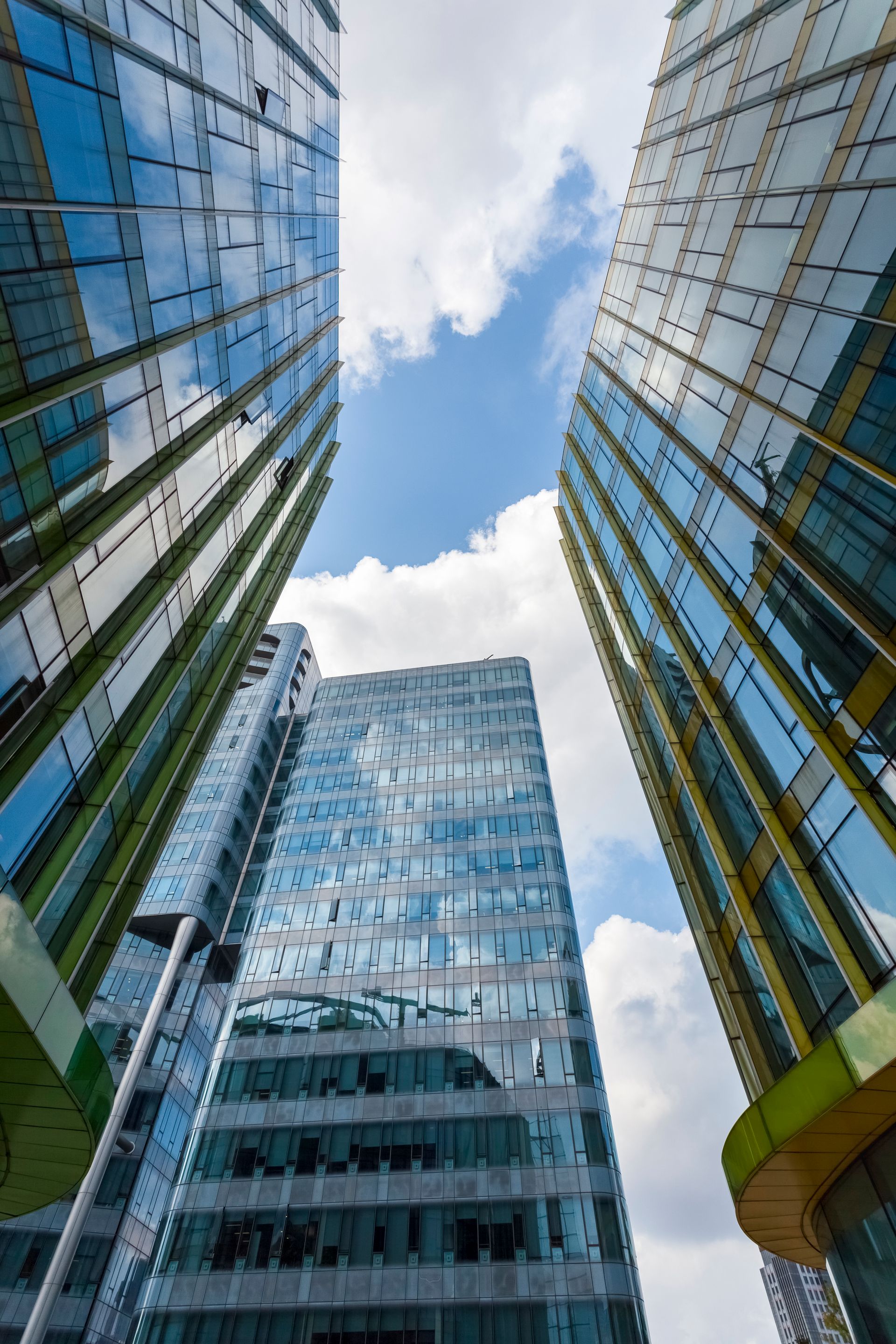 Looking up at a tall building with a blue sky in the background.