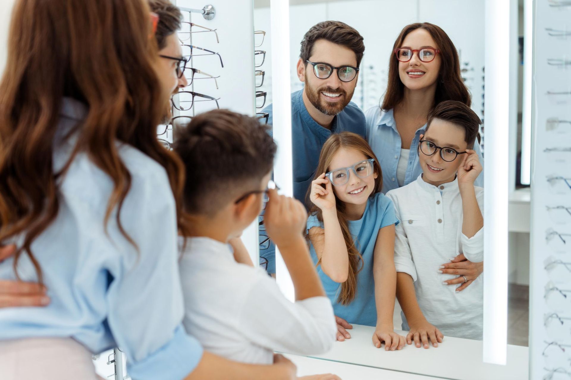 Family smiling in a mirror, getting ready in a bright bathroom.