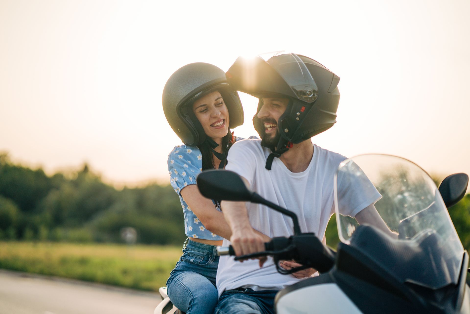 Happy couple riding on a motorcycle after getting motorcycle insurance in Loganville, GA Happy couple riding on a motorcycle after getting motorcycle insurance in Loganville, GA