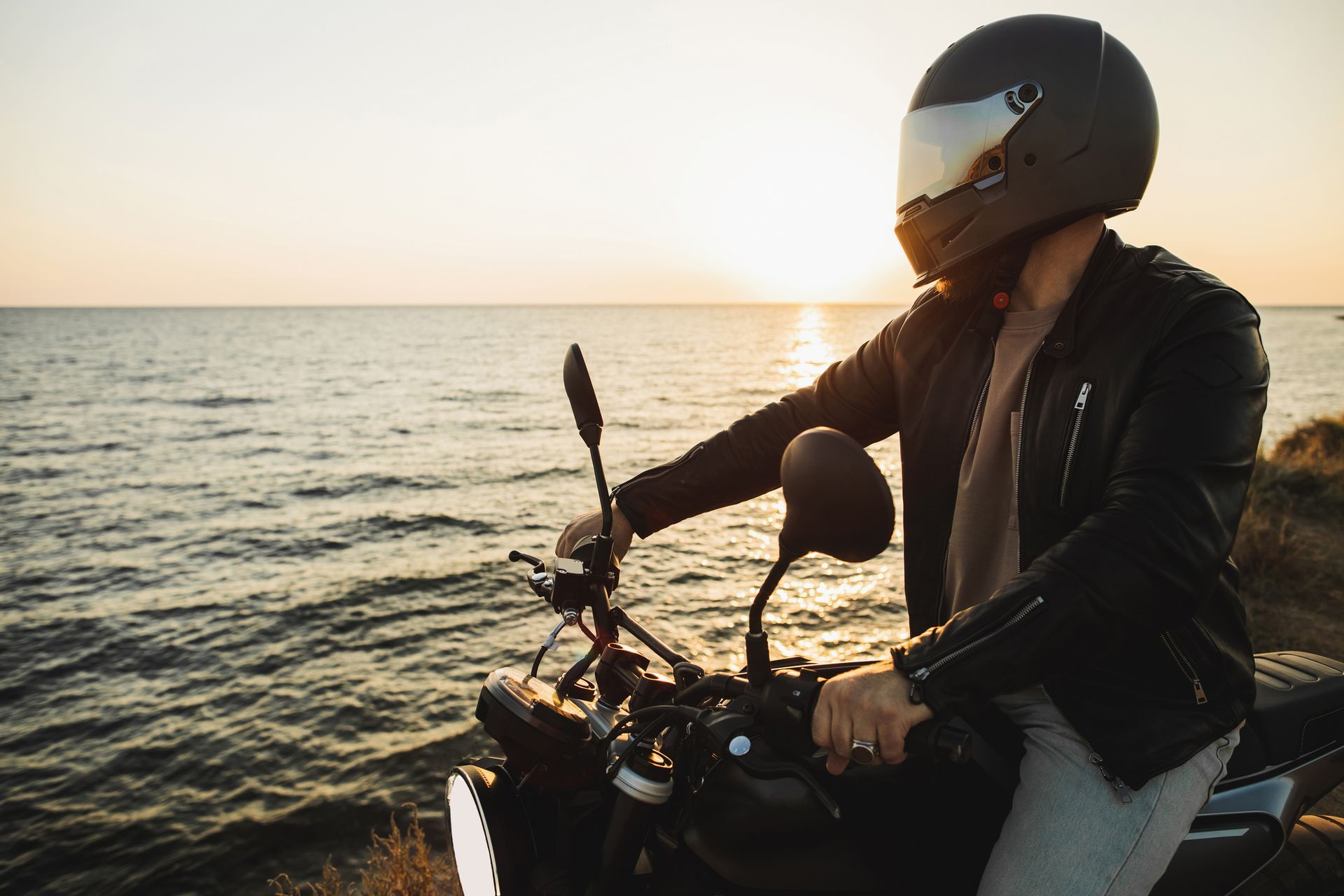 Biker in a helmet on his motorcycle after getting motorcycle insurance in Loganville, GA Biker in a helmet on his motorcycle after getting motorcycle insurance in Loganville, GA