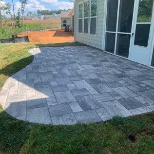 A paver concrete patio with free edges in Rock Hill, SC by Carolina Mega Concrete LLC