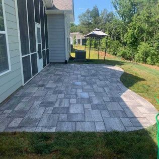 A paver concrete patio with free edges in Rock Hill, SC by Carolina Mega Concrete LLC