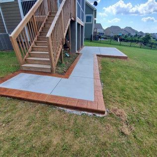 A custom concrete walkway to patio in Rock Hill, SC by Carolina Mega Concrete LLC