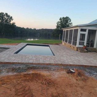 A travertine pool deck hardscape in Rock Hill, SC by Carolina Mega Concrete LLC