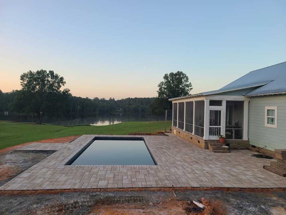 A travertine pool deck hardscape in Rock Hill, SC by Carolina Mega Concrete LLC