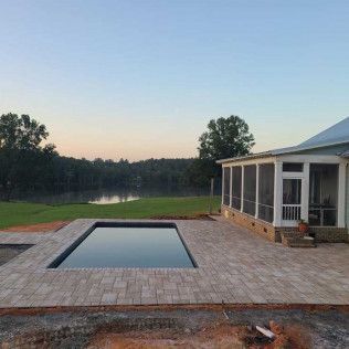 A travertine pool deck hardscape in Rock Hill, SC by Carolina Mega Concrete LLC