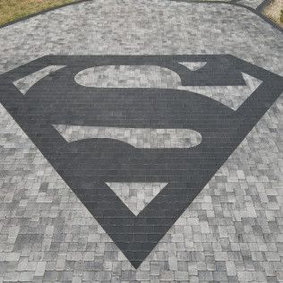 An up-close shot of the custom Superman logo concrete patio in Rock Hill, SC by Carolina Mega Concrete LLC