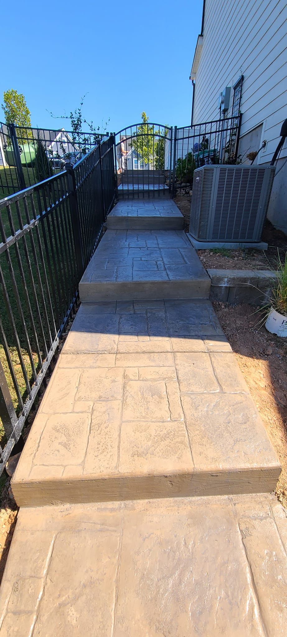 A travertine concrete walkway with step in Rock Hill, SC by Carolina Mega Concrete LLC