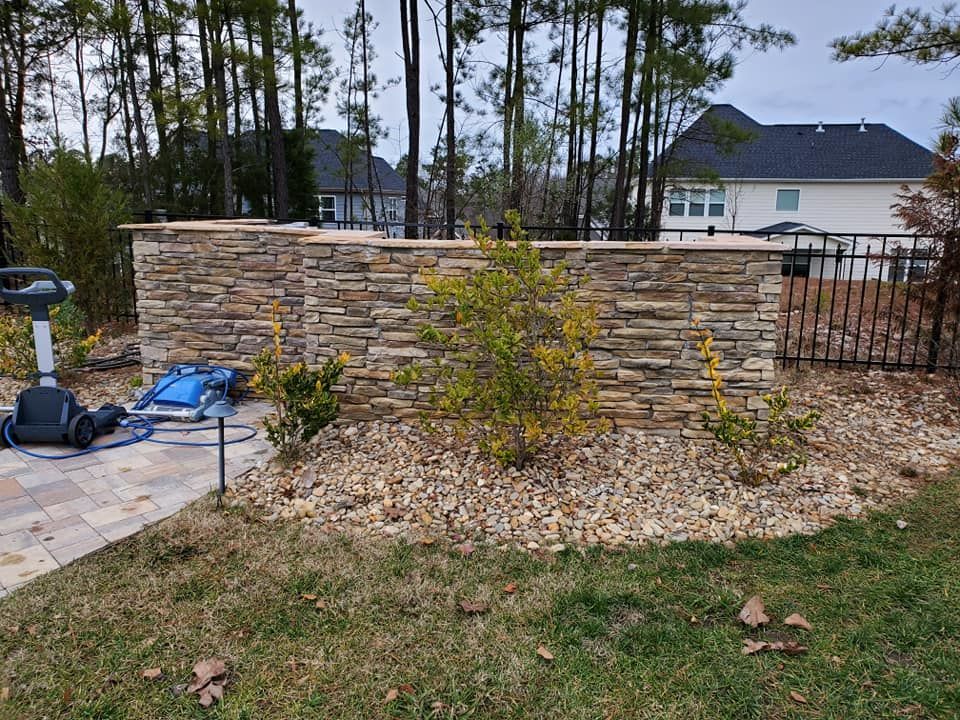 A travertine concrete retaining wall in Rock Hill, SC by Carolina Mega Concrete LLC