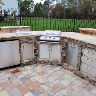 A travertine hardscape outdoor kitchen in Rock Hill, SC by Carolina Mega Concrete LLC