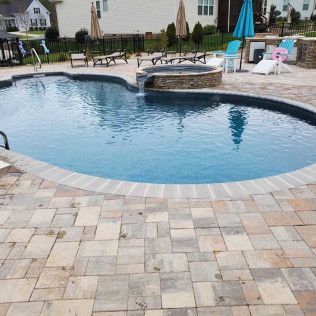 A travertine pool deck hardscape in Rock Hill, SC by Carolina Mega Concrete LLC