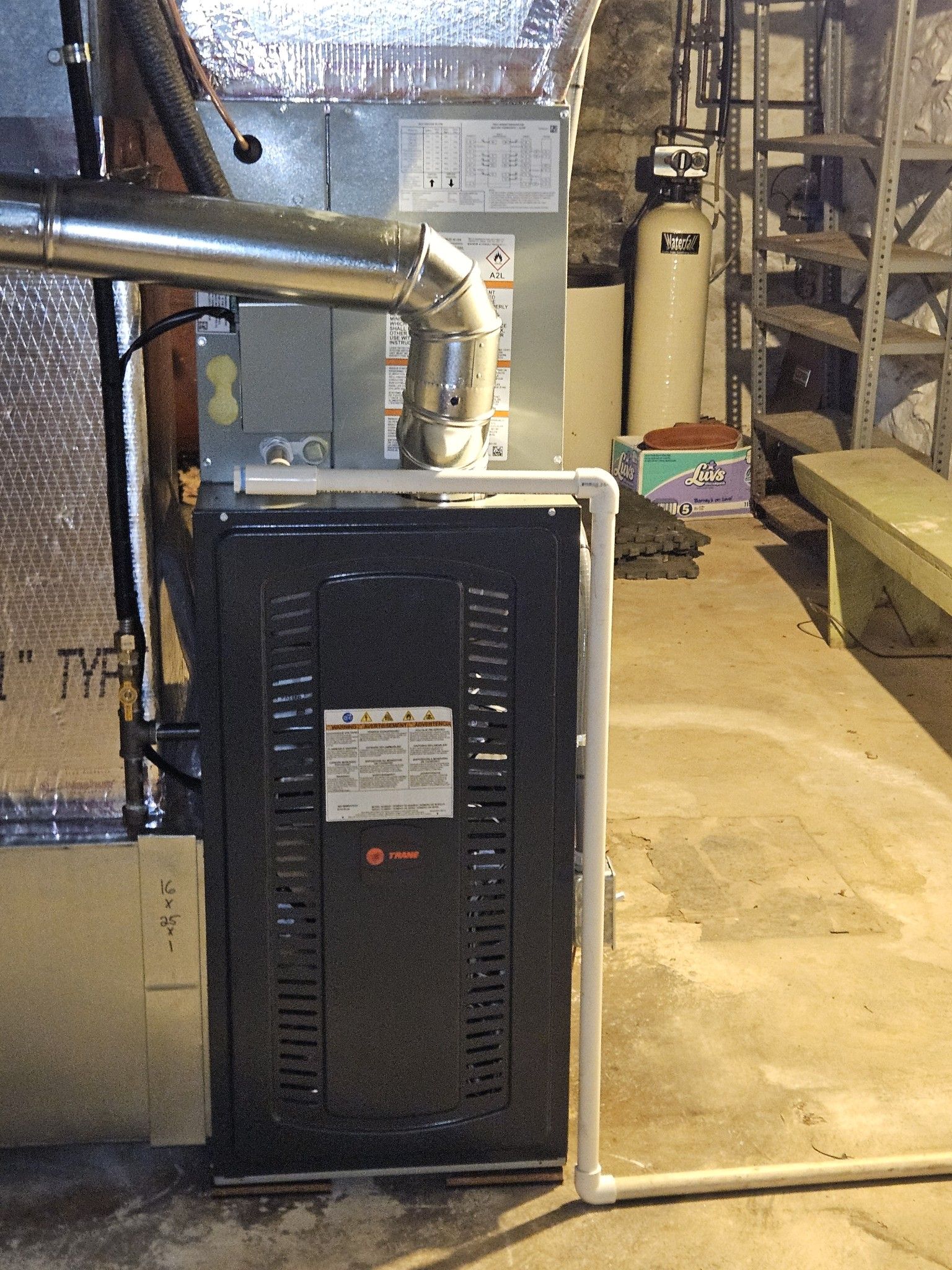 Furnace with metal ductwork in a basement setting.