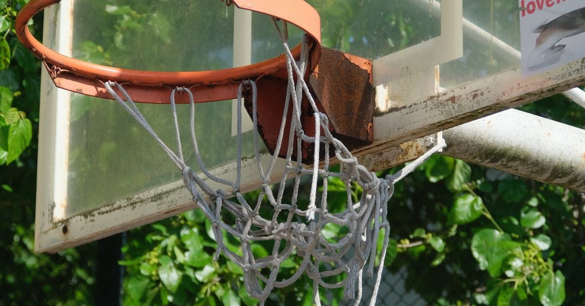 A close up of a basketball hoop with a broken net