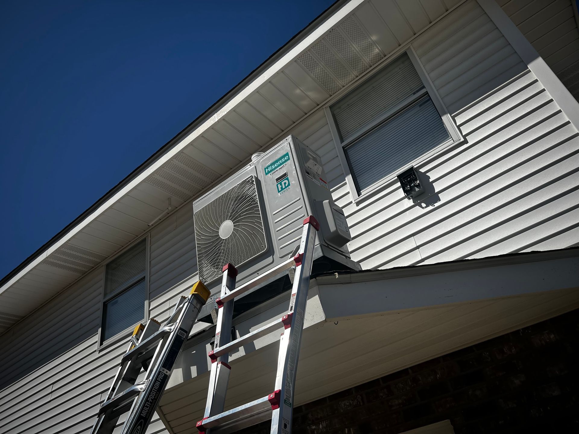 A ladder is attached to the side of a house.