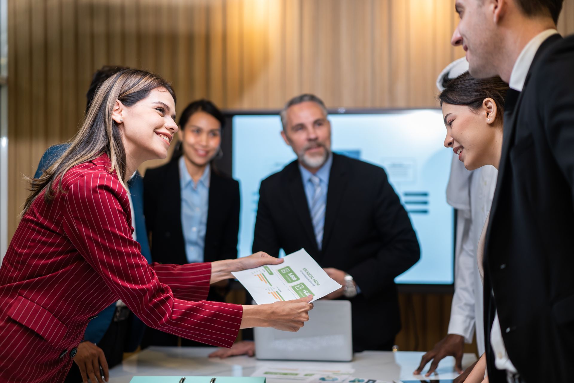 A group of business people are having a meeting in a conference room.