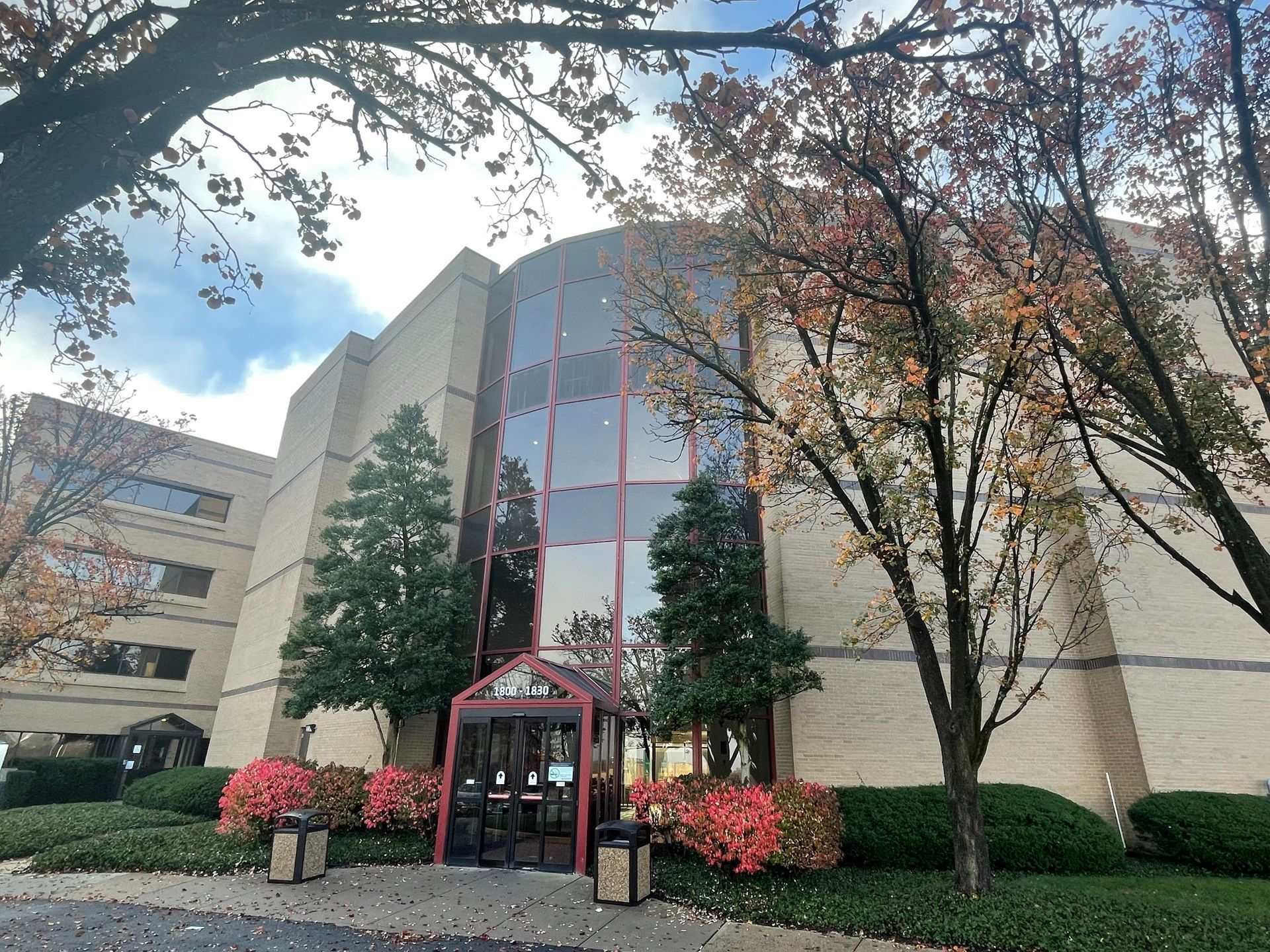 Outside of a building with trees surrounding it.
