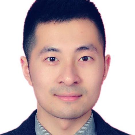 Asian man with short dark hair, wearing a suit jacket and collared shirt, smiling slightly.