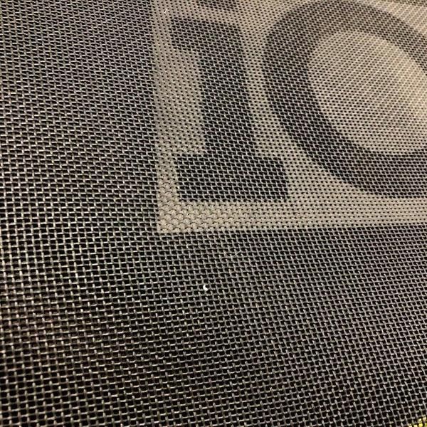 A Close up Of a Stainless Steel Wire Mesh with A Logo on It — Edmonds Landscaping Supplies in Bohle Plains, QLD