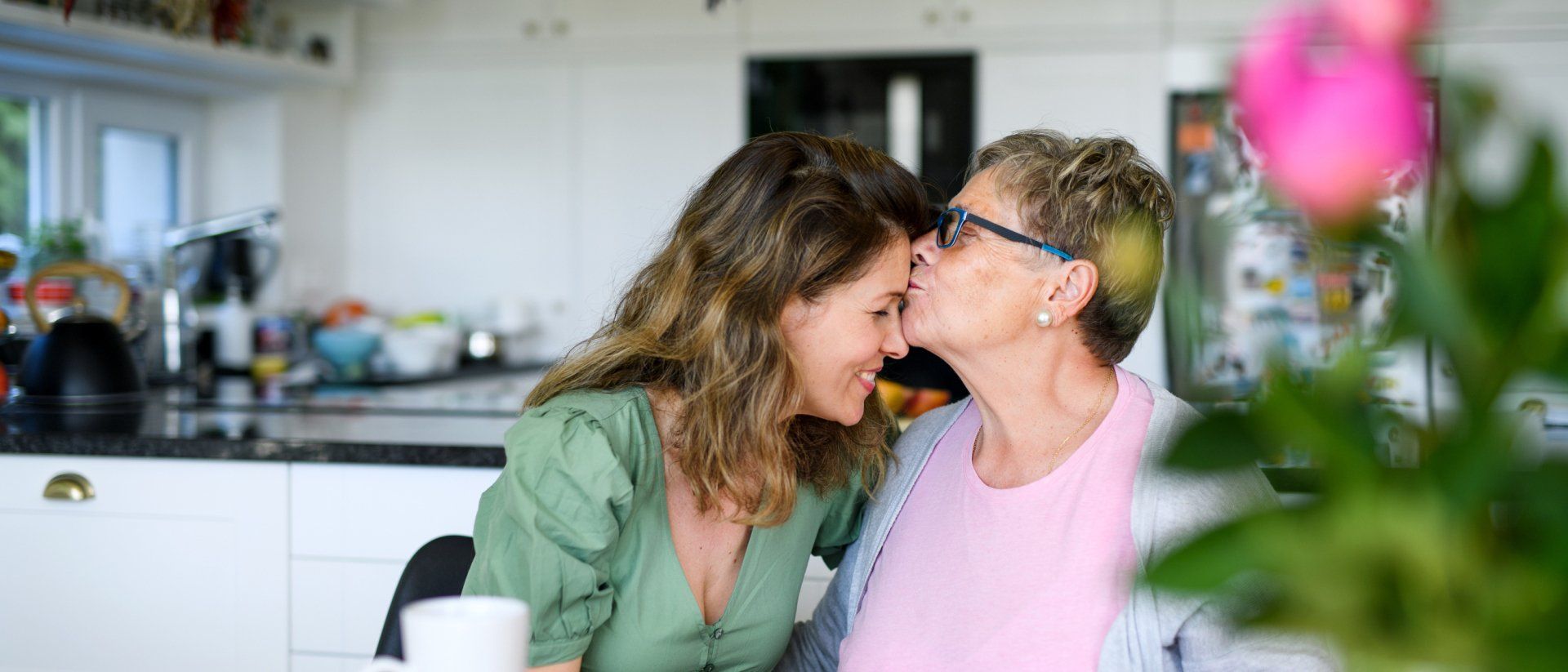 Senior Mother Kissing Adult Daughter — Waterloo, IA — Kvale Insurance