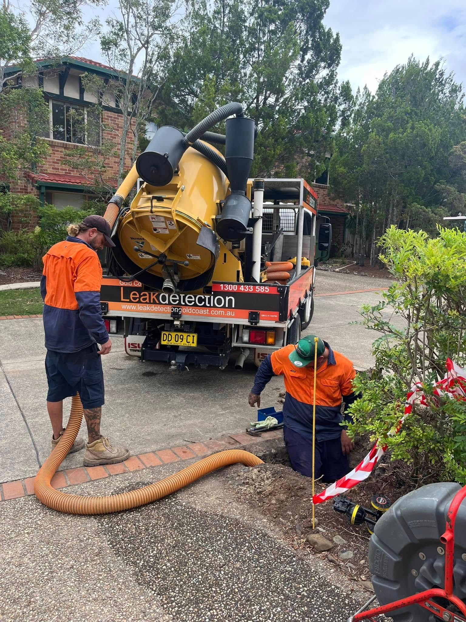Two Workers Use a Vacuum Truck to Clear a Drain in a Residential Setting — Gold Coast Leak Detection in Tamborine Mountain, QLD