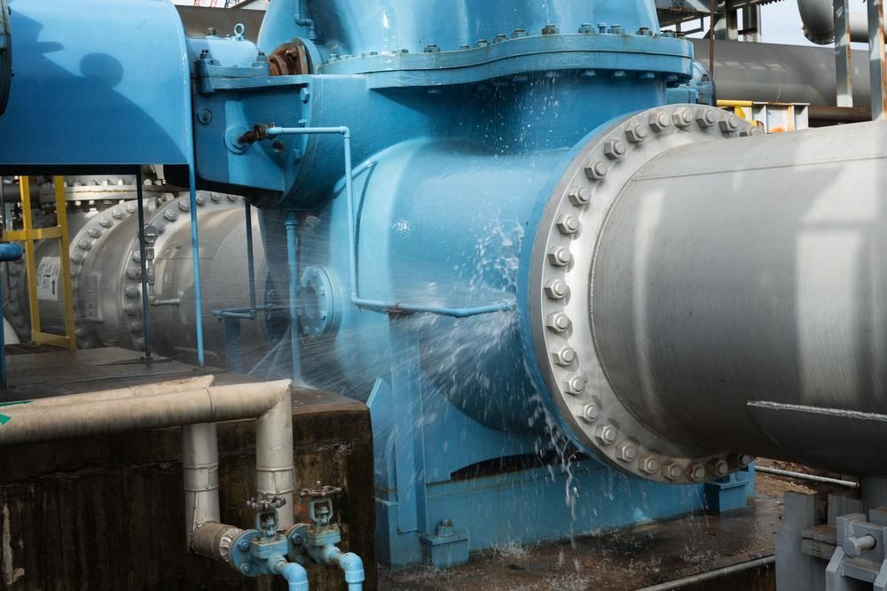 A Large Blue Pipe is Being Sprayed With Water in a Factory — Gold Coast Leak Detection in Mudgeeraba, QLD