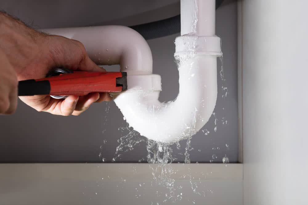 Plumber Fixing a Leaking Pipe in the Bathroom — Gold Coast Leak Detection in Mudgeeraba, QLD 