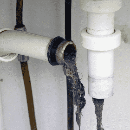 A Close Up of a Drain Pipe With a Lot of Dirty Water Coming Out of It — Gold Coast Leak Detection in Mudgeeraba, QLD