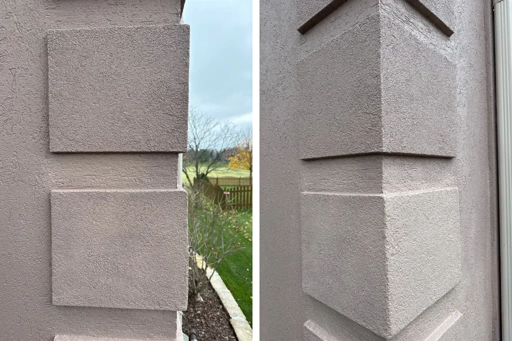 A close up of a corner of a building with a triangle on it.