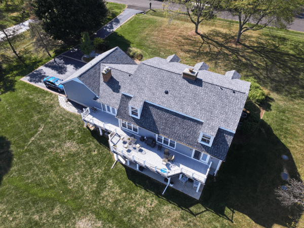 An aerial view of a large house with a gray roof.
