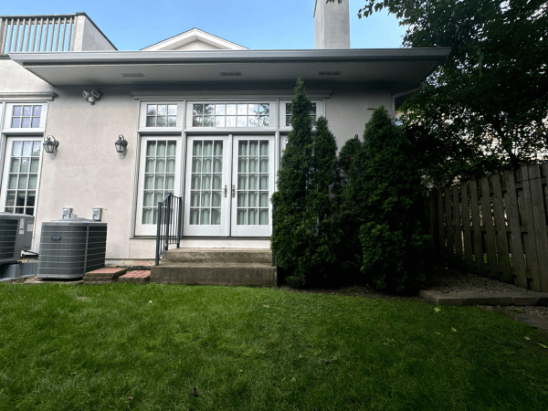 A house with a lot of windows and a fence