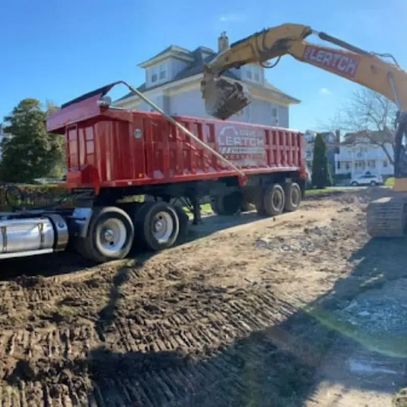 A dump truck parked in front of a house.