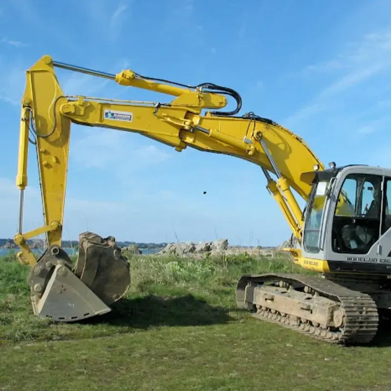 Yellow and black excavator on construction site.