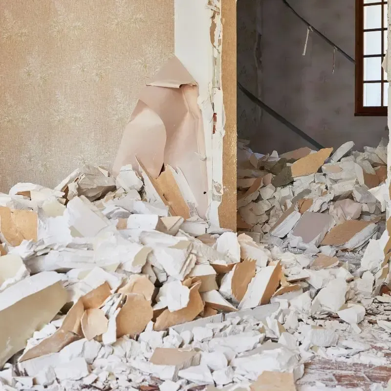 A room filled with rubble and debris, showing signs of destruction and chaos