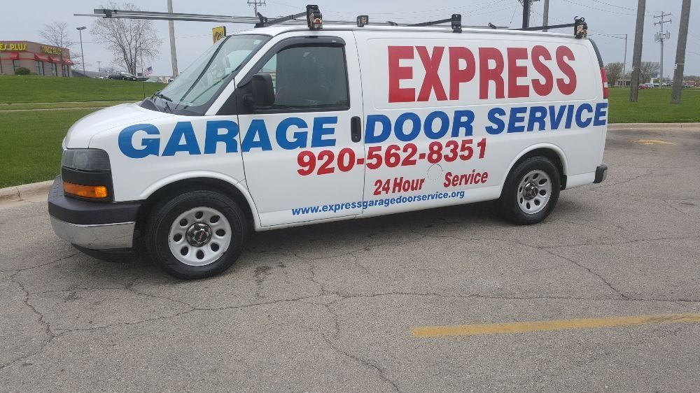 White garage door service van with “EXPRESS” lettering parked outdoors in a lot