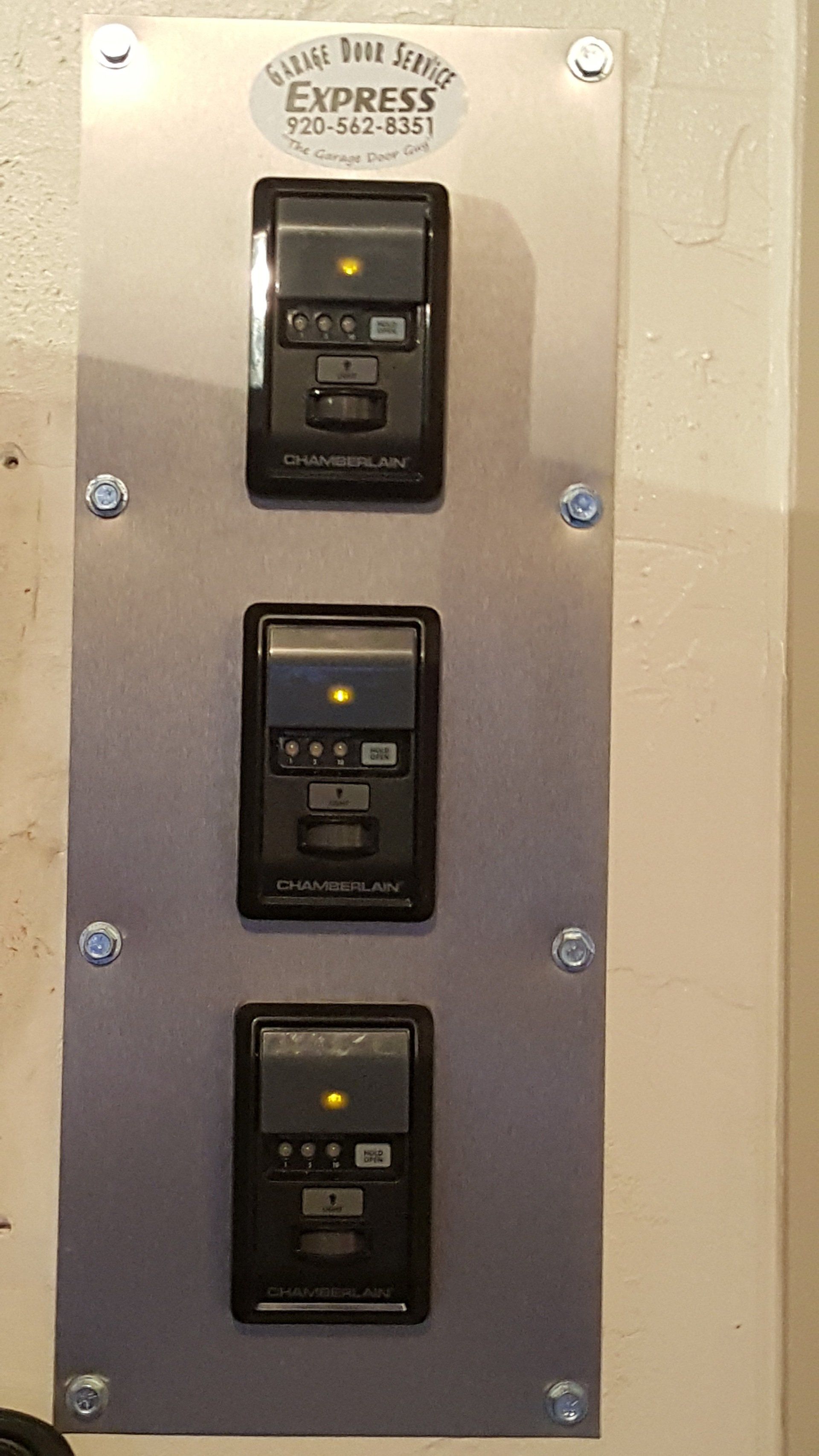 Three black wall switches on a metal plate labeled “No Trespassing Express”
