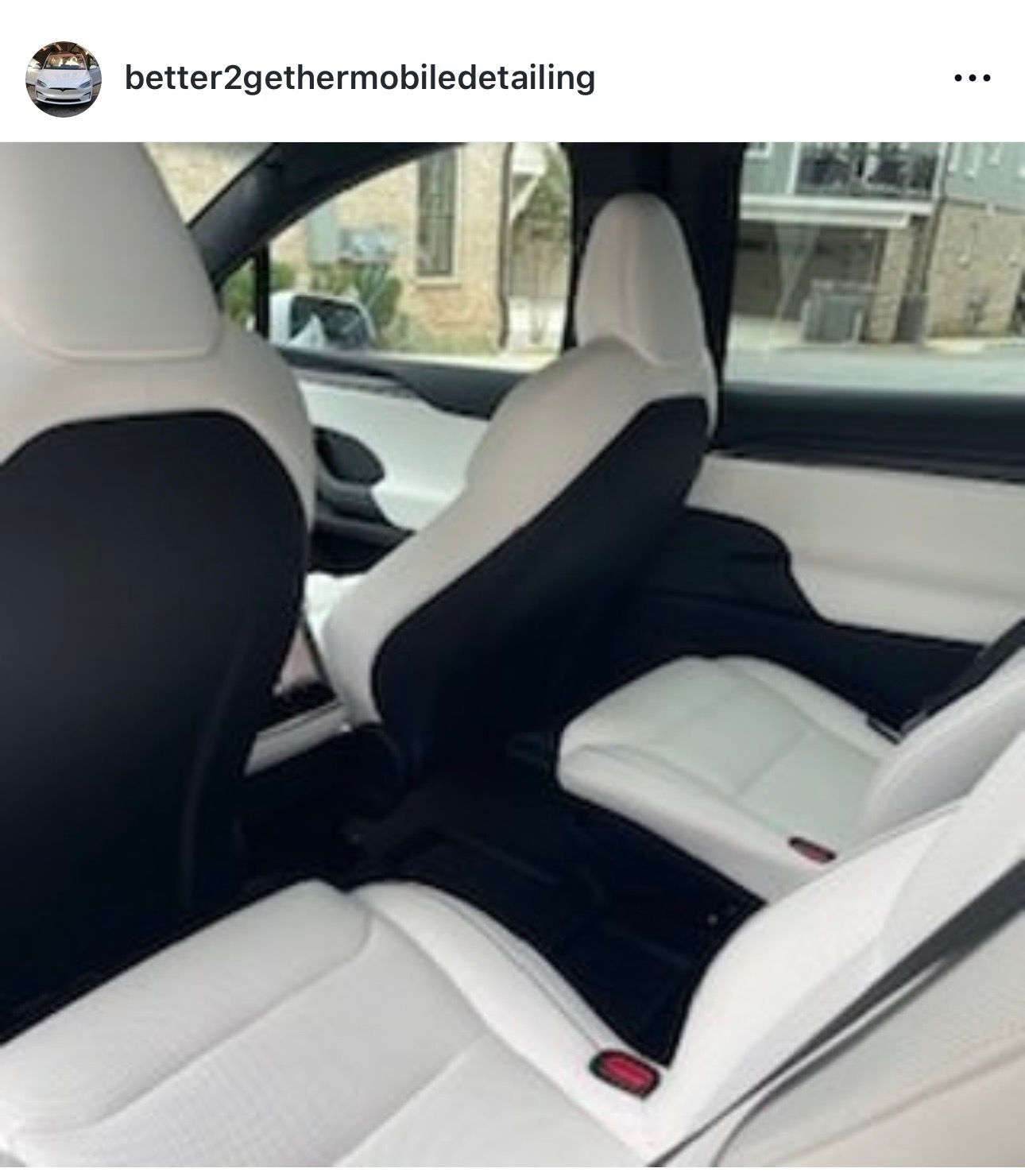 Car interior with rear seats folded down, showing a center armrest and front dashboard view.