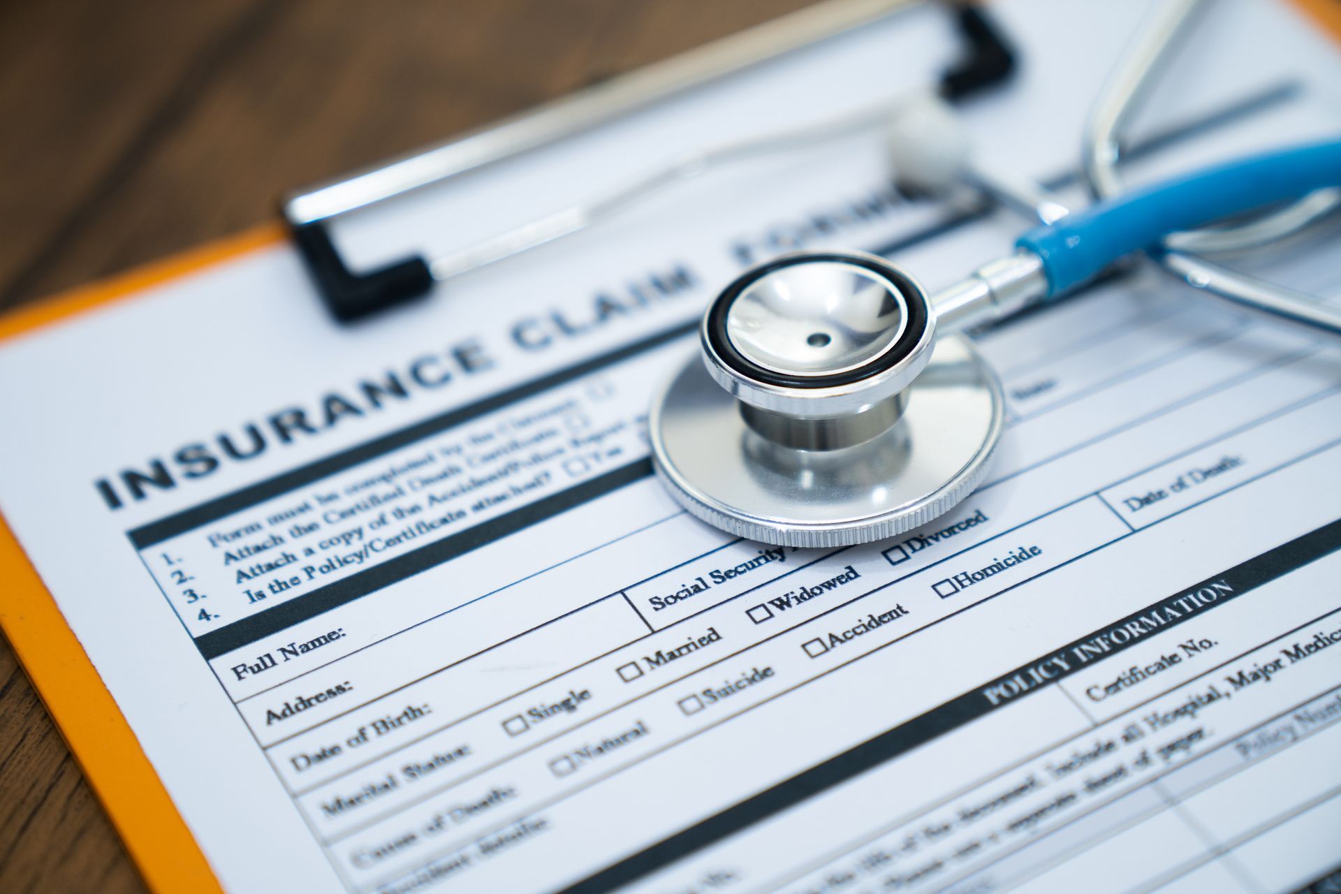 Insurance claim form with a stethoscope resting on top.