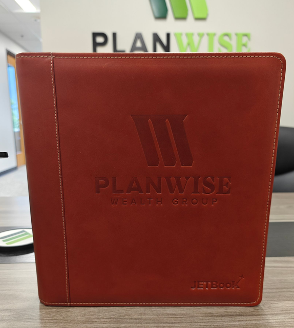 Brown leather portfolio with PLANWISE logo, standing in front of a Planwise office sign.