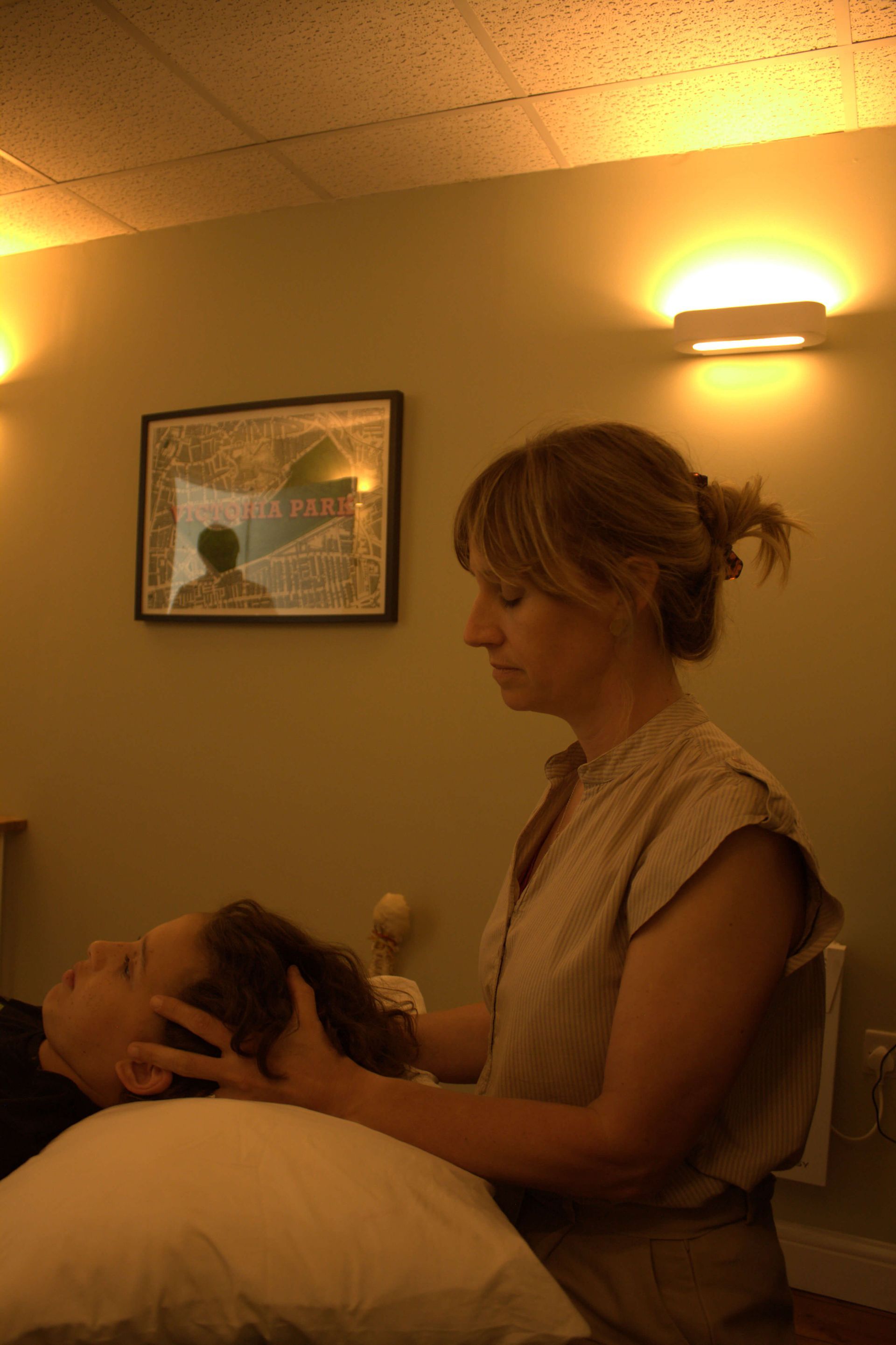 Osteopath does cranial osteopathy on child