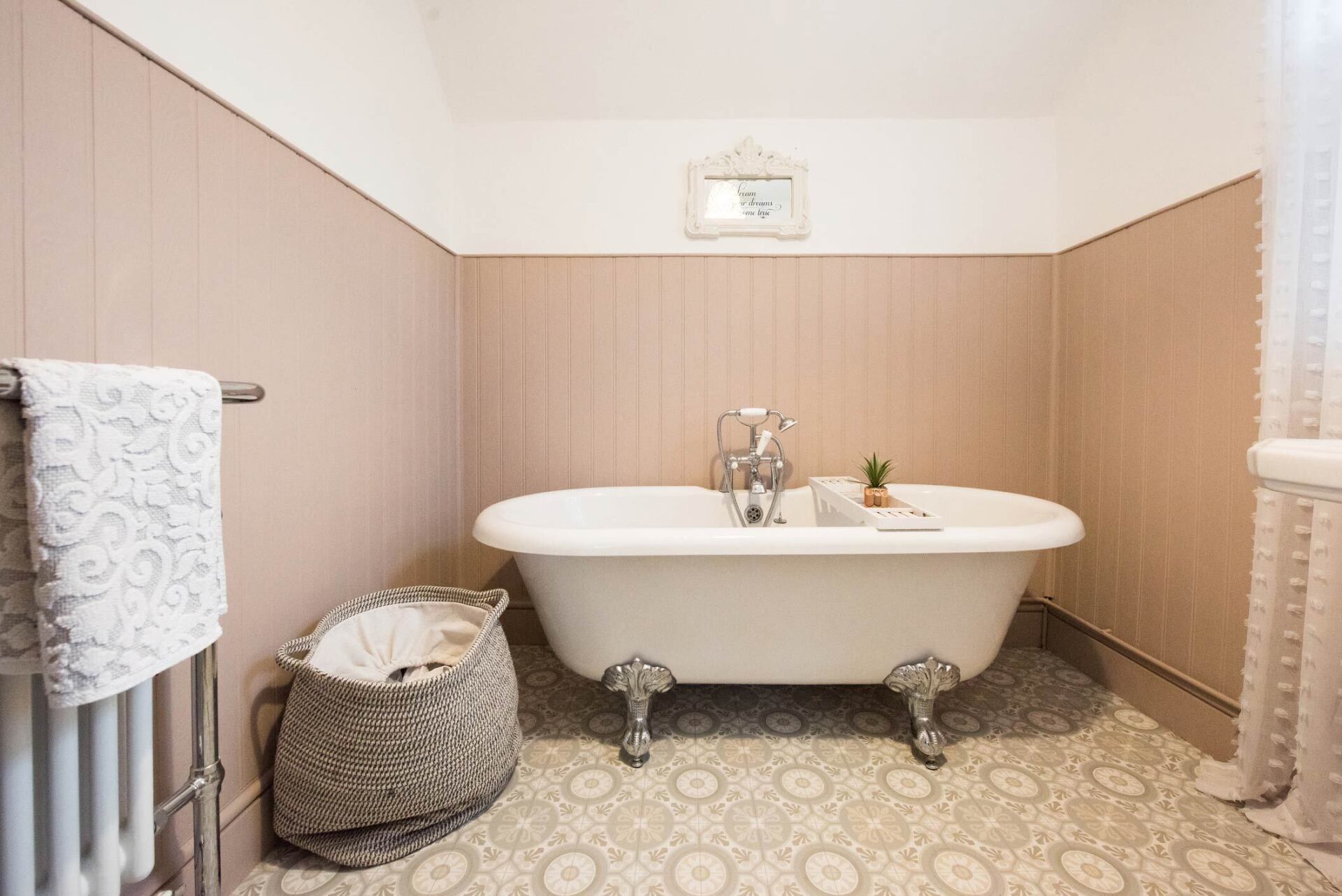 A Bathroom With Pastel Pink Wood Paneling — Houston, TX — Richter’s Services Inc.