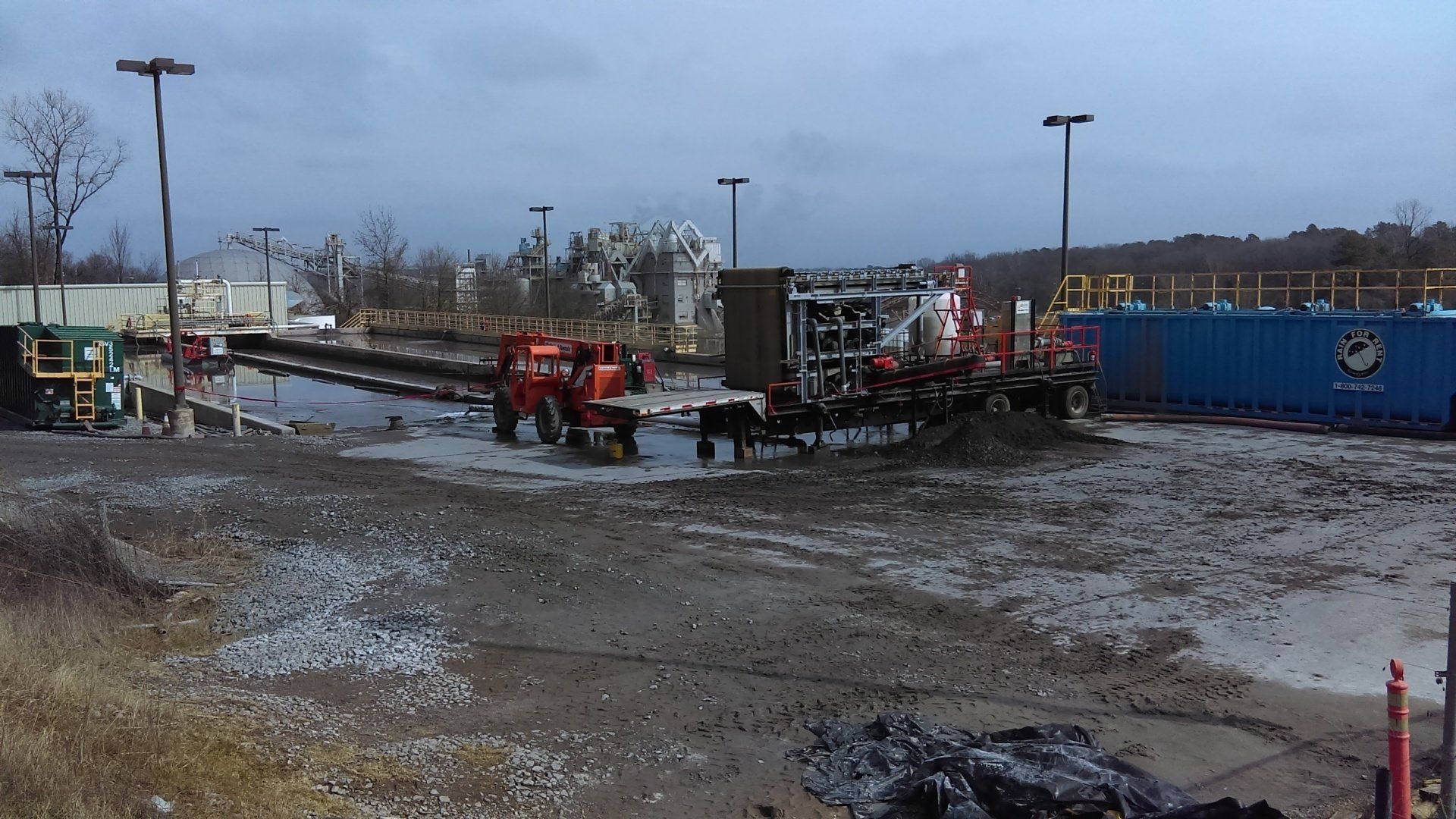 A lot of trucks are parked in a muddy field