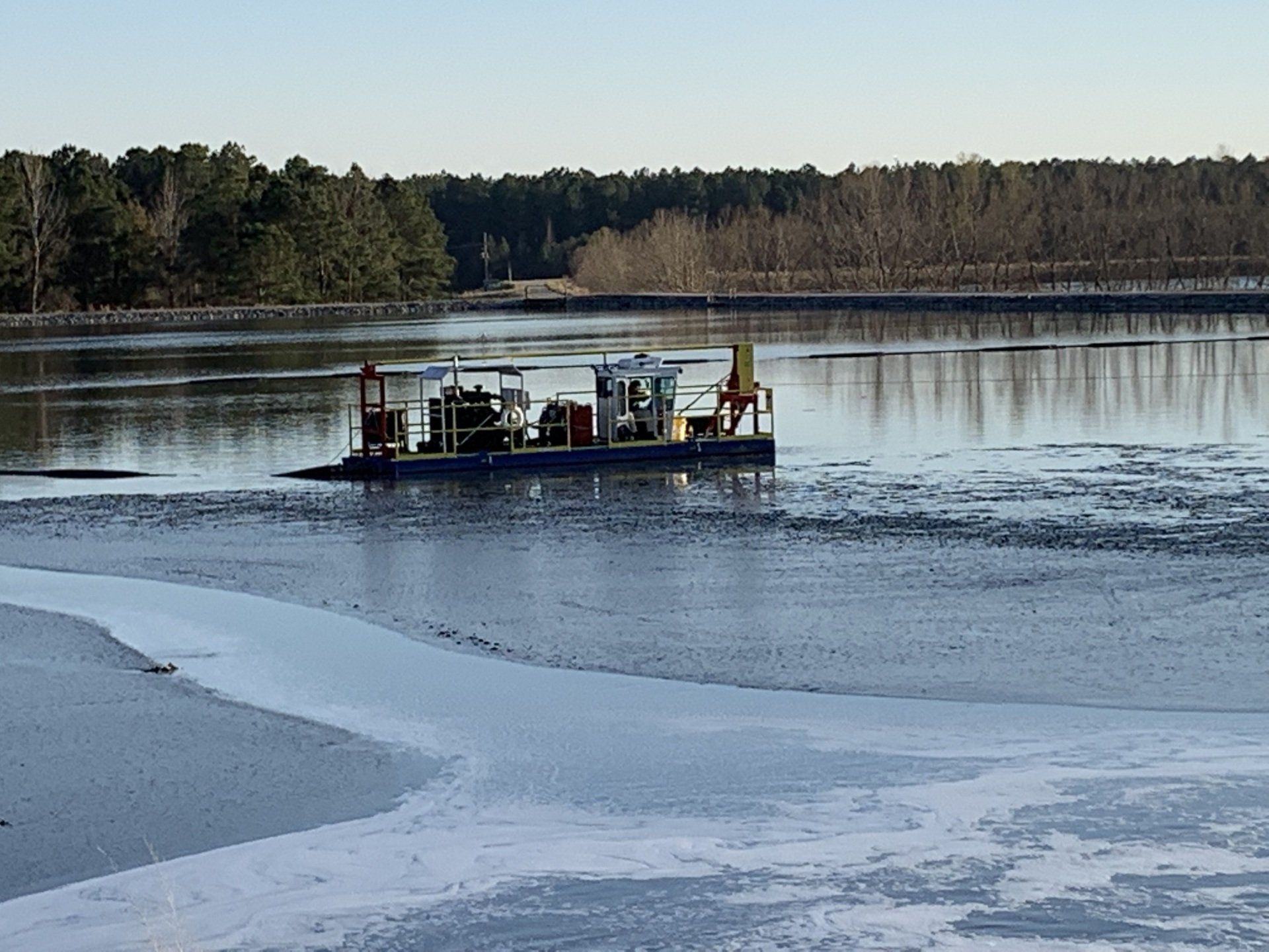 A boat is floating on top of a frozen lake.