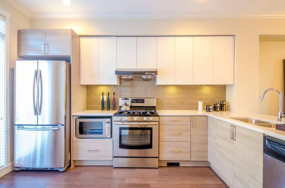 A Modern Kitchen With Stainless Steel Appliances — Kitchens Factory Direct in Port Macquarie, NSW