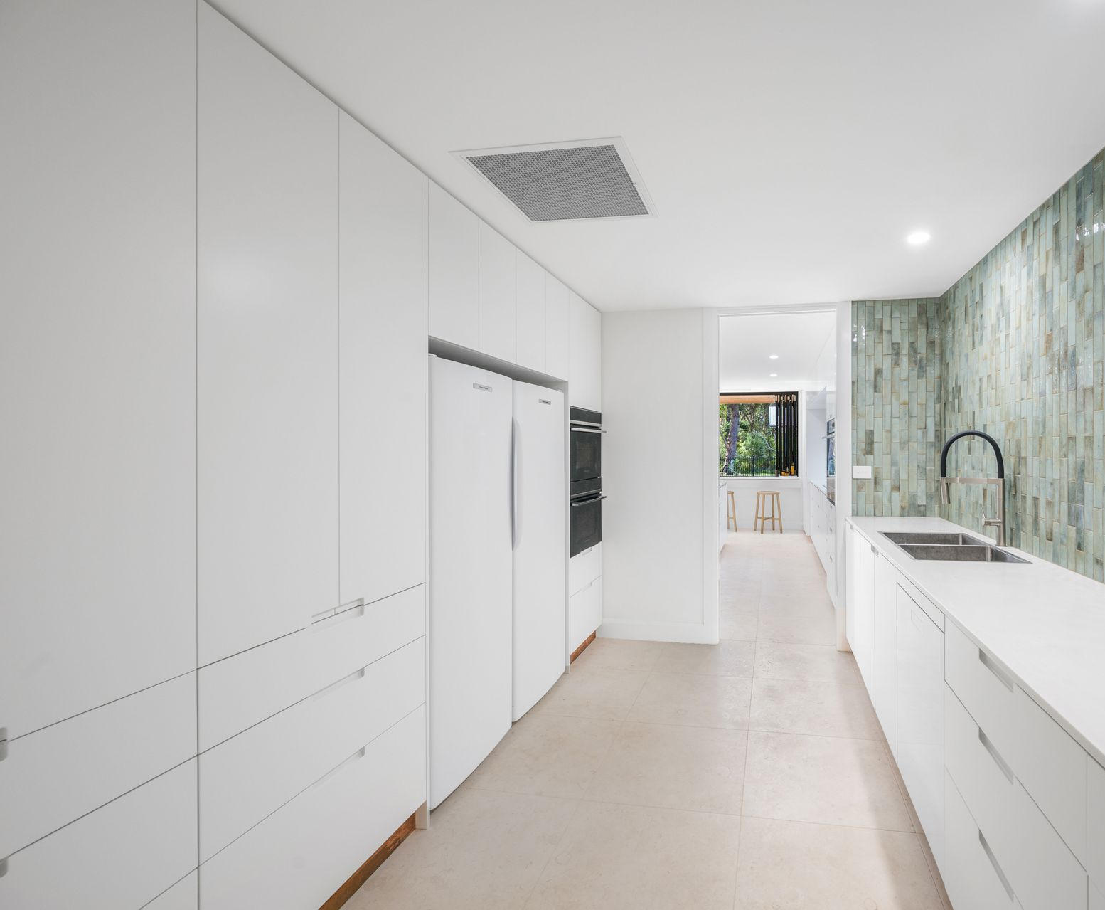 A Modern White and Black Kitchen With Upper and Lower Cabinets — Kitchens Factory Direct in Port Macquarie, NSW