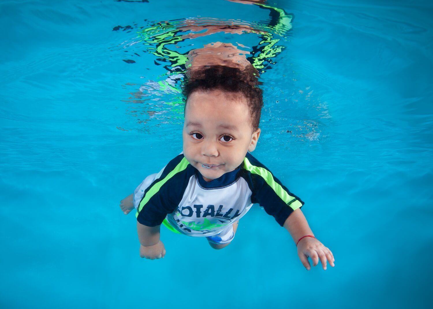 Child Swimming in the pool alone