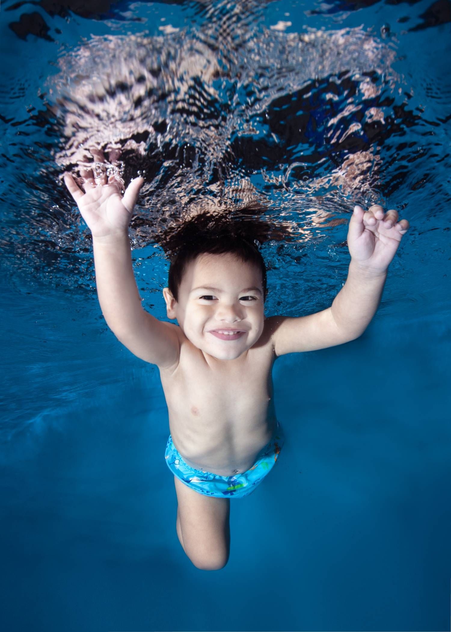 Boy Swimming Underwater Photo of a Boy Swimming Underwater